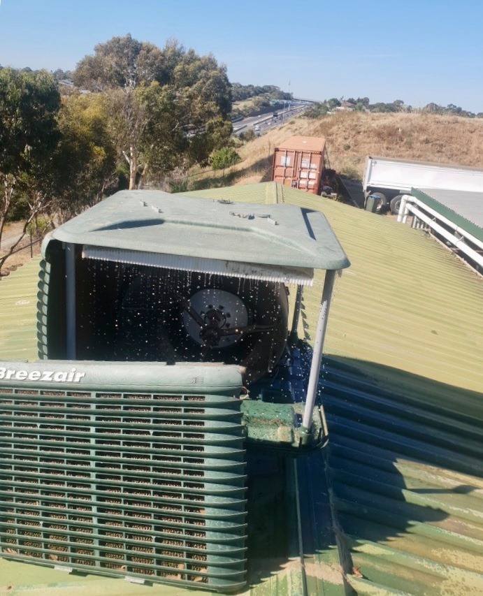 Ken Hall technician performing air conditioner maintenance