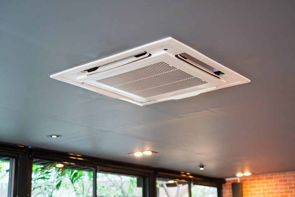 Technician installing ducted reverse cycle air conditioning
